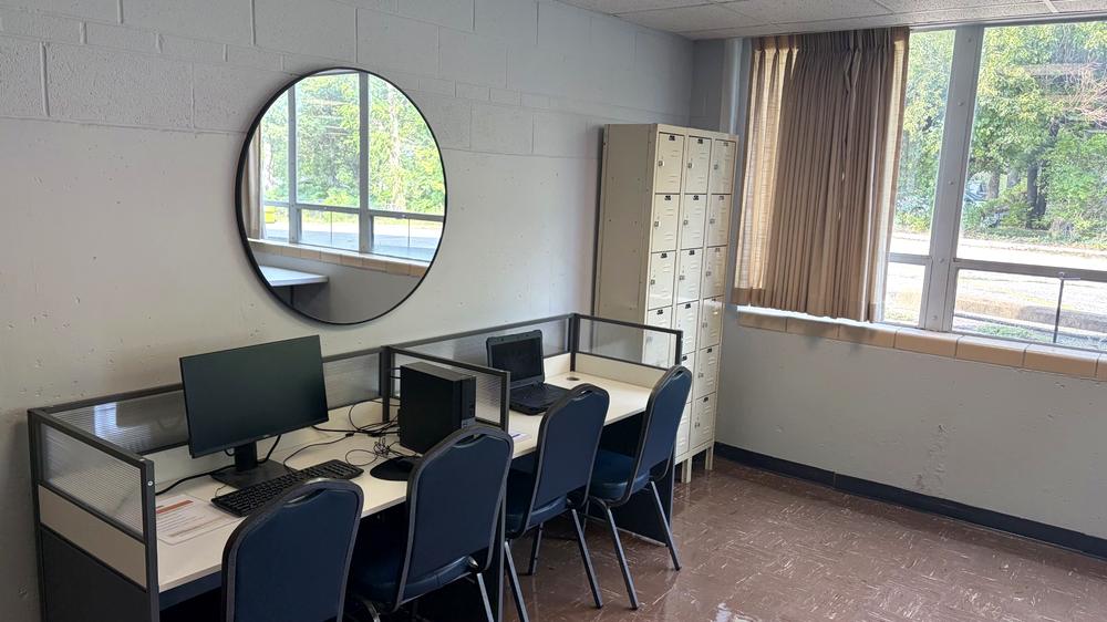 Computer workstations and personal lockers at CORE Foundations, beside a window looking outside